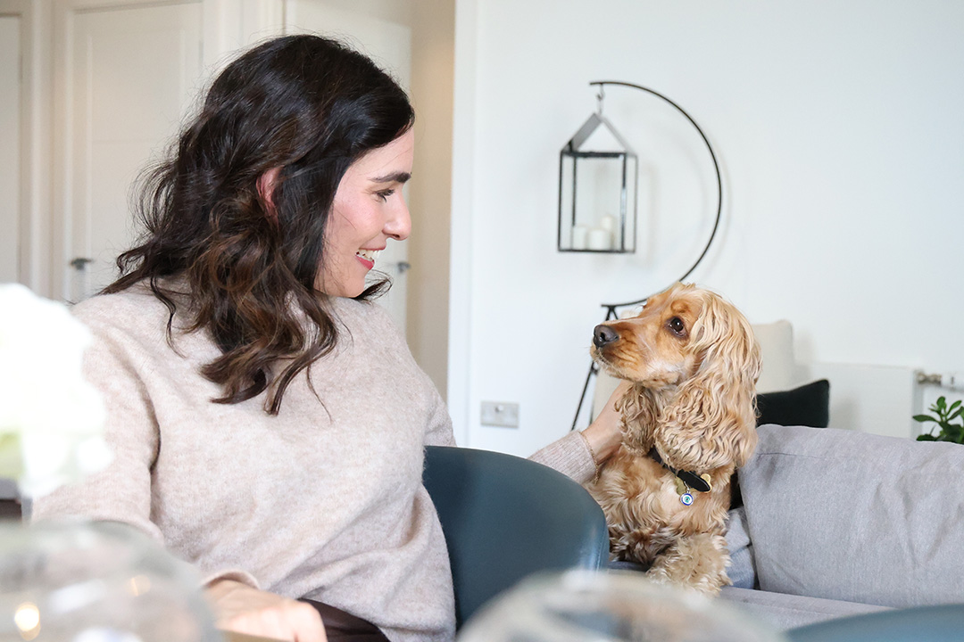 Woman with dog in pet-friendly apartment 